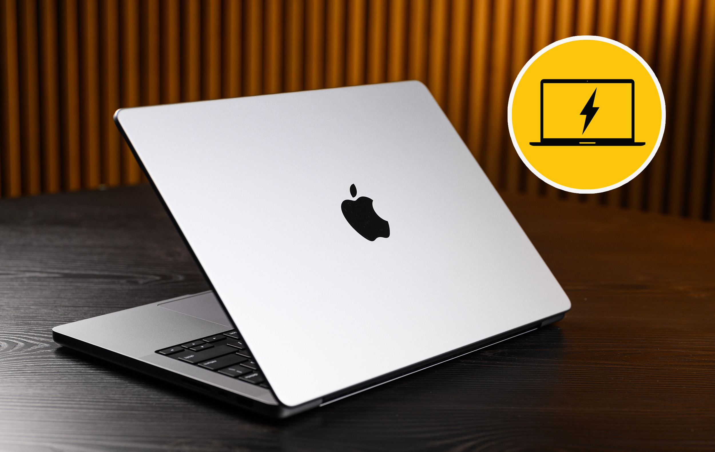 Angle shot of MacBook Pro on table. Sonnet notebook charging icon badge shown superimposed in the upper right corner of the photo.